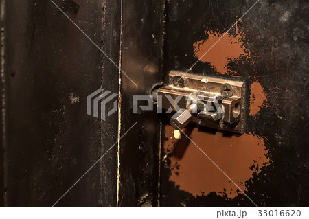 Door latch on wooden surface Door latch on wooden surface 33016620