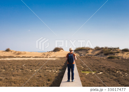 Outdoors lifestyle image of travelling man back Outdoors lifestyle image of travelling man back 33017477