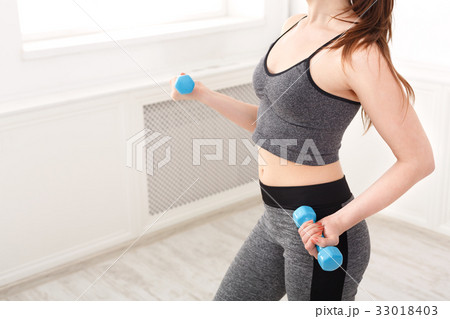 Fitness model woman with dumbbells at studio Fitness model woman with dumbbells at studio 33018403