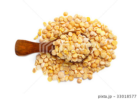 Dried yellow peas in wooden spoon isolated Dried yellow peas in wooden spoon isolated 33018577
