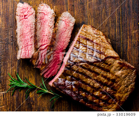 Sliced grilled medium rare beef steak served on 33019609