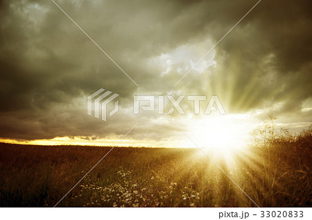Dark storm clouds and sunbeams Dark storm clouds and sunbeams 33020833