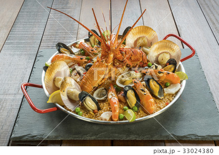Paella with fresh lobster, scallops, mussel, prawn Paella with fresh lobster, scallops, mussel, prawn 33024380