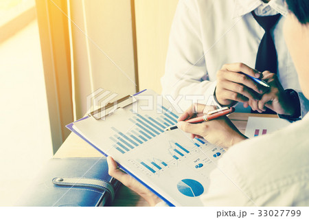 Businessman pointing the results on paperwork 33027799