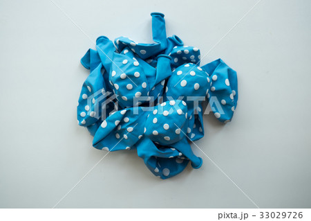 Deflated blue pastel white dots rubber balloon Deflated blue pastel white dots rubber balloon 33029726