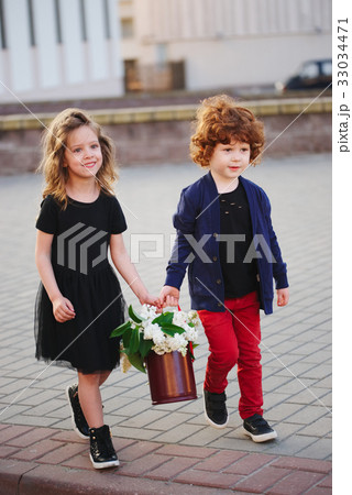 little boy and girl with big lilac bouquet 33034471