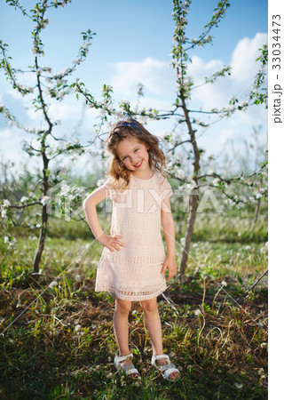 beautiful little girl in blooming garden 33034473