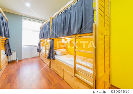 Hostel dormitory beds arranged in room 33034616