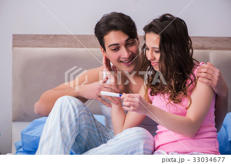 Young family with pregnancy test results 33034677