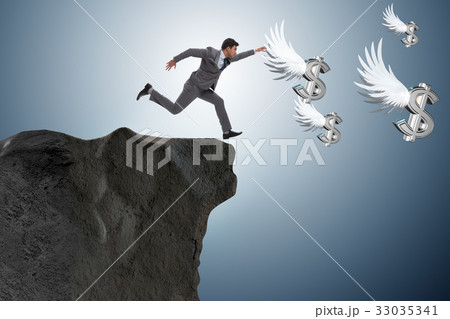 Businessman chasing angel dollars in business 33035341