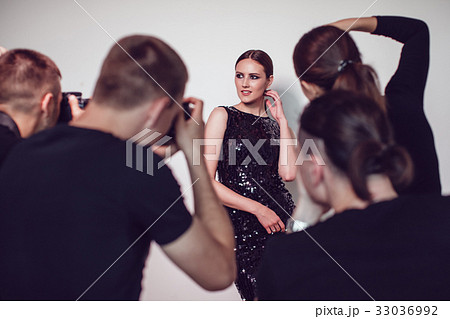 Photographers paparazzi take photos of woman in 33036992