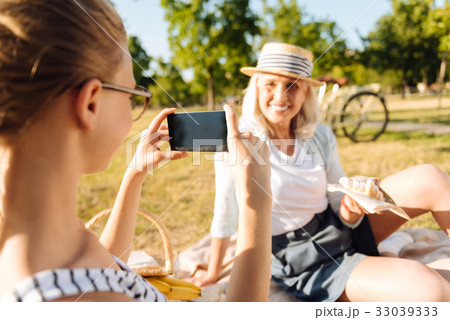Cheerful senior woman posing in the picnic Cheerful senior woman posing in the picnic 33039333