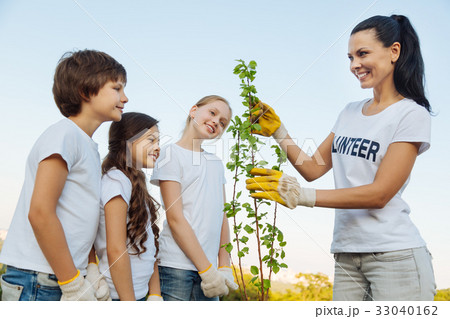 Delighted woman showing young plant 33040162