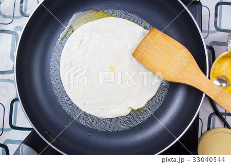 Chef cooking roti in the pan home mate style 33040544