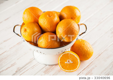 Fresh oranges in a colander 33040696