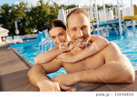 Loving young couple hugging in a swimming pool 33040850