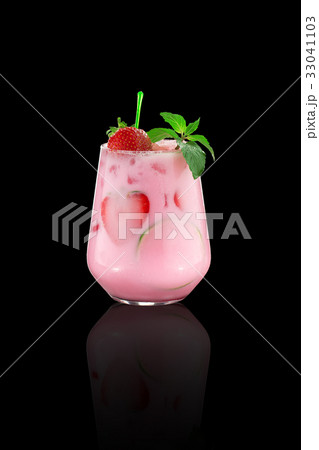 Tropical strawberry cocktail over dark background Tropical strawberry cocktail over dark background 33041103