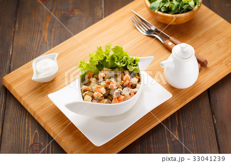 Russian salad Olivier on a white plate Russian salad Olivier on a white plate 33041239