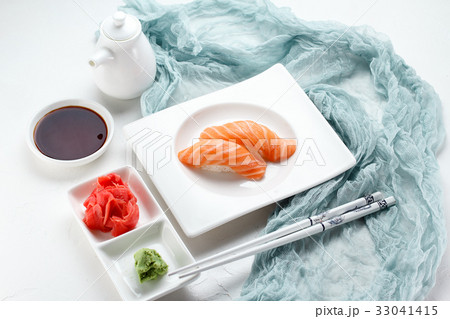 Japanese cuisine. Sushi on a white plate Japanese cuisine. Sushi on a white plate 33041415
