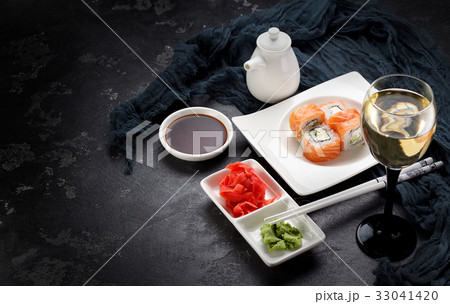 Sushi roll on a white plate, decorated Sushi roll on a white plate, decorated 33041420