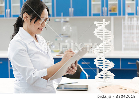 Serious smart researcher noting down her 33042018