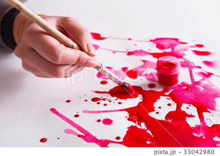Brush and paint jar in hands. Artist creating Brush and paint jar in hands. Artist creating 33042980