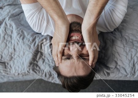 Portrait of a man holding his face Portrait of a man holding his face 33045254