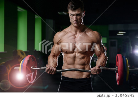 Muscular handsome athletic bodybuilder fitness model posing afte 33045845