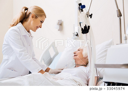 Caring gentle doctor making her patient feeling 33045974