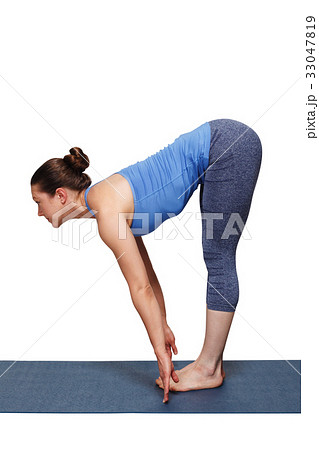 Woman doing yoga asana Uttanasana - standing 33047819