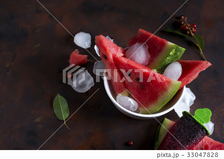 Triangle shaped watermelon slices placed with ice Triangle shaped watermelon slices placed with ice 33047828