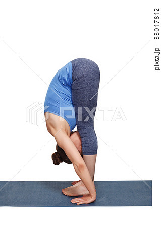 Woman doing yoga asana Uttanasana - standing Woman doing yoga asana Uttanasana - standing 33047842