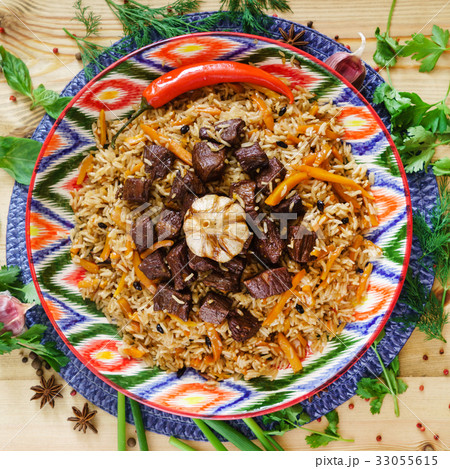 Pilaf with mutton, carrots, onions, garlic, pepper and cumin. A traditional dish of Asian cuisine. Pilaf with mutton, carrots, onions, garlic, pepper and cumin. A traditional dish of Asian cuisine. 33055615