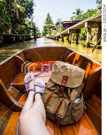 woman sitting on canal boat in floating market woman sitting on canal boat in floating market 33057054