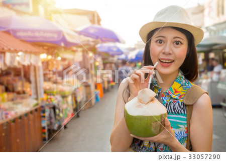woman traveler holding coconut water 33057290