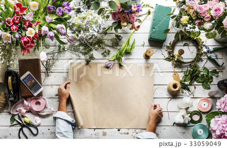 Flower decorative arrangement on wooden table 33059049