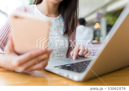 Woman use of cellphone and laptop computer 33062876