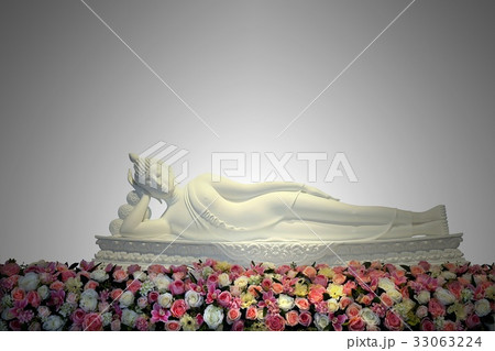 White reclining buddha statue with colorful flower White reclining buddha statue with colorful flower 33063224