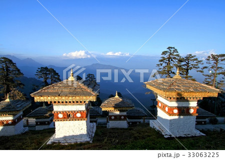 The 108 chortens (stupas) with layer of mountains The 108 chortens (stupas) with layer of mountains 33063225