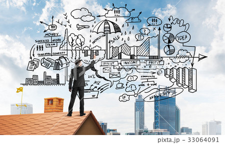 Rear view of businessman on house roof drawing his new business strategy. Mixed media Rear view of businessman on house roof drawing his new business strategy. Mixed media 33064091