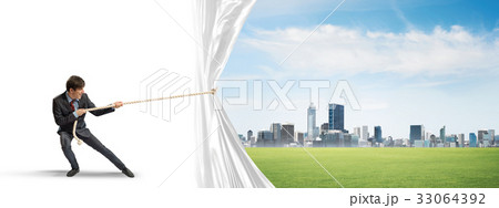 Young man opening white curtain and presenting modern city landscape Young man opening white curtain and presenting modern city landscape 33064392