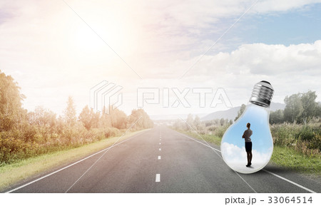Businesswoman inside light bulb Businesswoman inside light bulb 33064514