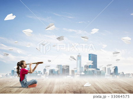 Concept of careless happy childhood with girl looking in spyglass 33064575