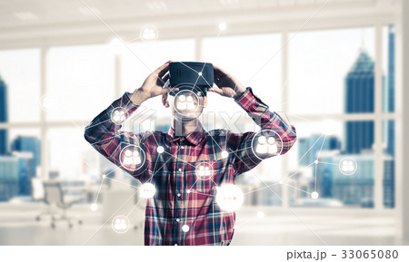 Guy wearing checked shirt and virtual mask demonstrating some em 33065080