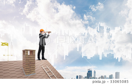 Engineer man standing on roof and looking in spyglass. Mixed media 33065085