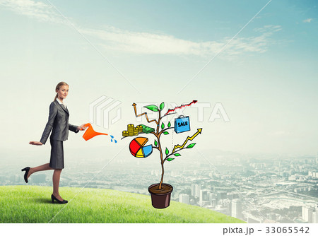 Young businesswoman outdoors watering drawn growth concept with can Young businesswoman outdoors watering drawn growth concept with can 33065542