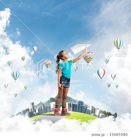 Concept of careless happy childhood with girl dreaming about future Concept of careless happy childhood with girl dreaming about future 33065980