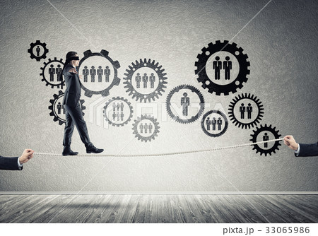 Business concept of risk support and assistance with man balancing on rope Business concept of risk support and assistance with man balancing on rope 33065986