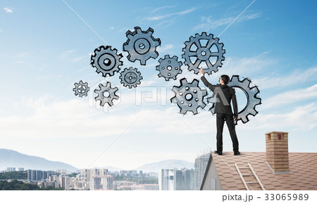 Mister boss on brick roof standing with back and draw teamwork concept. Mixed media 33065989