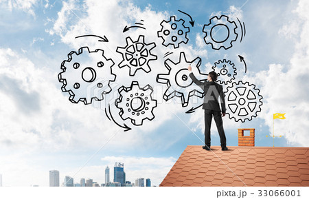 Mister boss on brick roof standing with back and draw teamwork concept. Mixed media 33066001